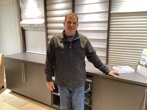 Smiling man in the dealership showroom