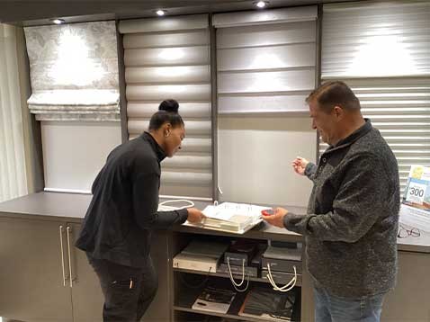 Man and woman talking in the dealership showroom