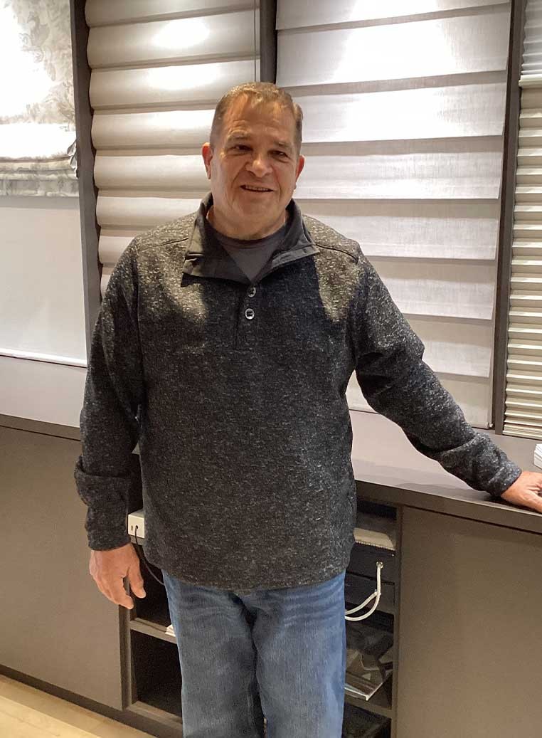 Smiling man in the dealership showroom
